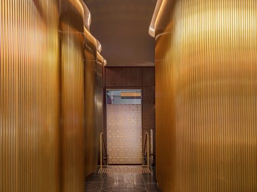 Squillace architects designed the renovations and Di Emme fabricated and installed the luxe gold wall on the stairway between the levels.